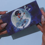 open magical guardian 8 pan duochrome lunar palette, swatches of blue duochrome eyeshadow, sparkly colorshifting arm swatches of the magical guardian lunar palette. Sparkly duochrome swatches on dark skin. 